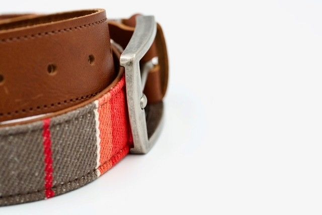 Close-up of striped Franklin belt and buckle entering from the left