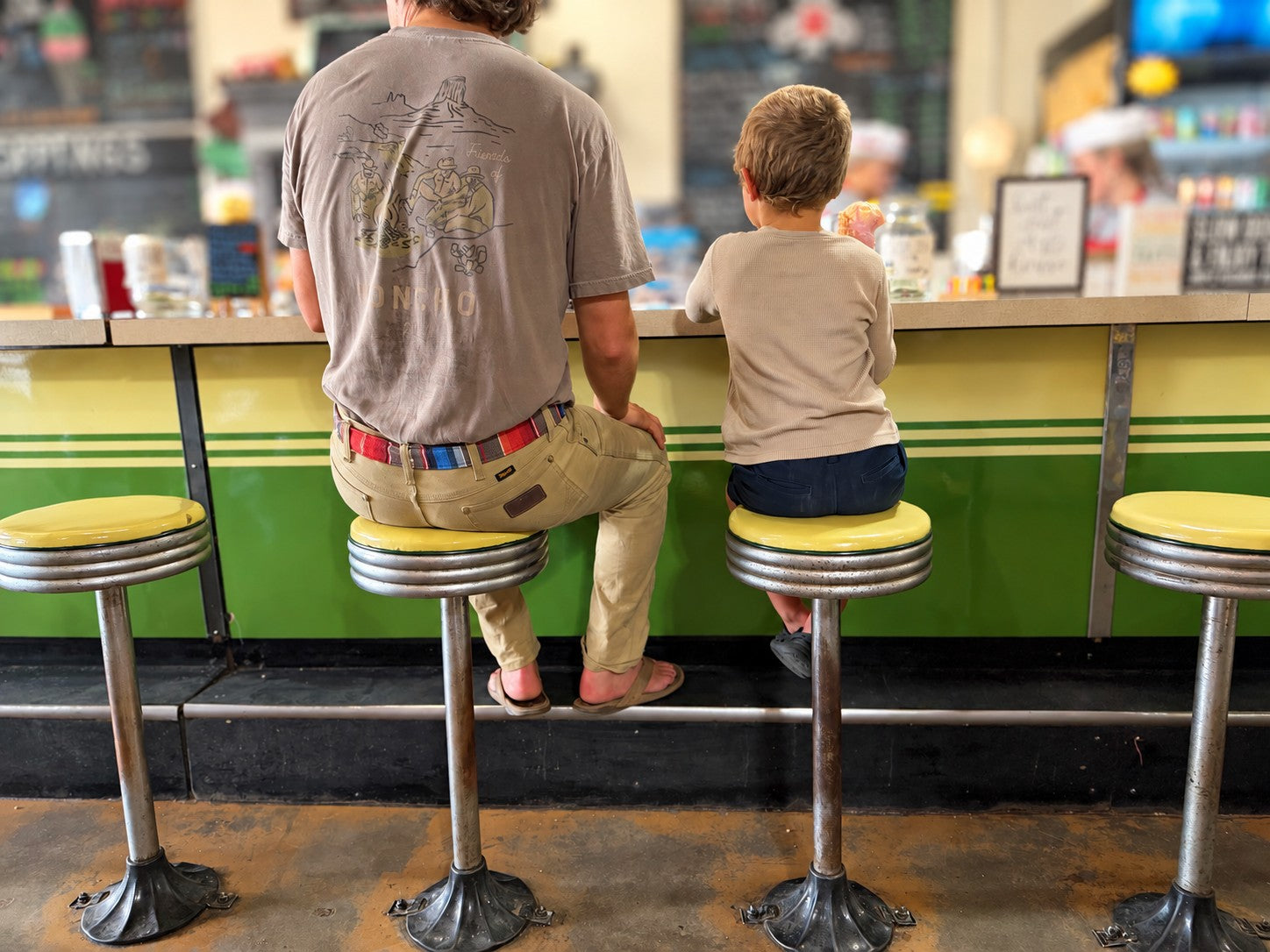 Chance and Brooks sitting together at an ice cream counter, with a Franklin belt in view